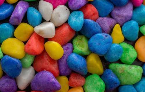 Pile of little colorful pebbles as stone background