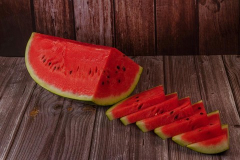 Close-up of fresh watermelon slices on a wooden table