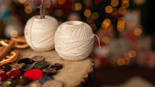 A Christmas scene with beautiful bokeh in the background and sewing tools. In studio