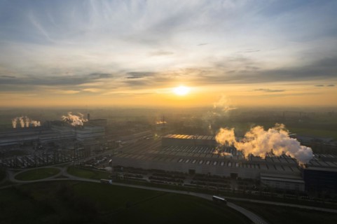 Drone aerial view of working steel plant at dawn