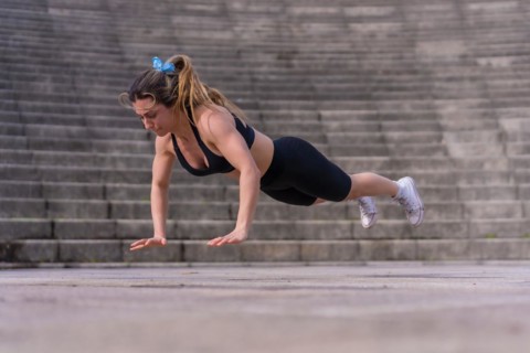 Caucasian young woman doing fitness in a city park