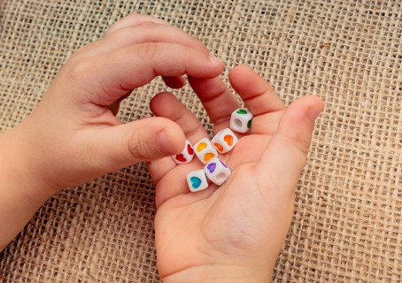 Little cubes with heart shape in hand on canvas