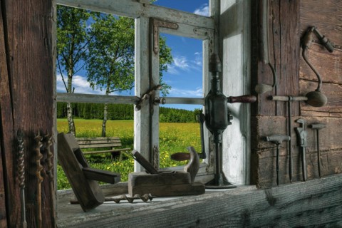 Rustic workshop with old tools and view out of the window into the landscape