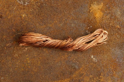 Red metal copper wire scrap materials recycling of waste from manual wire tearing. Closeup of copper waste in the form of copper wires
