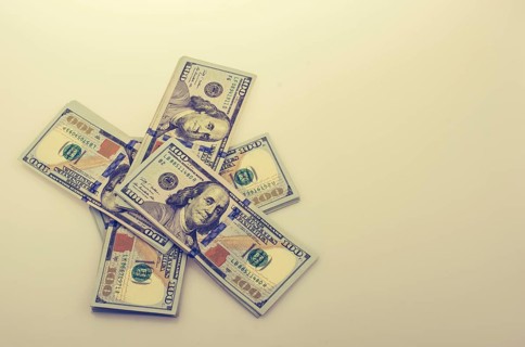 American 100 dollar banknote bundles placed on white background