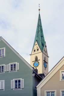 Pointed gable and steeple with clocks of the St. Mang Church