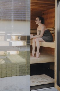 Woman sitting in Finnish sauna