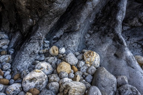 Rocky coast and colourful stones at Praia da Adraga