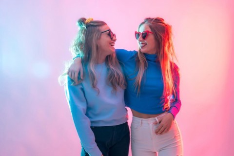 Two young blonde caucasian women dancing in disco
