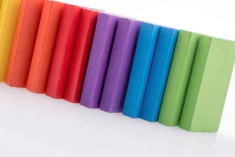 Colorful Domino Blocks in a line on a white background