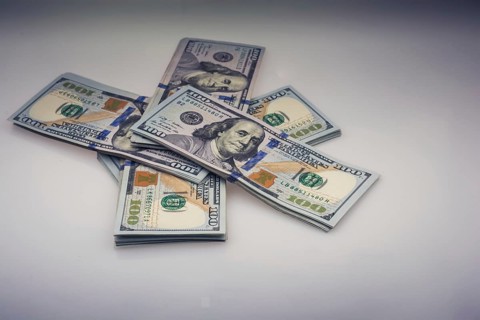 American 100 dollar banknote bundles placed on white background