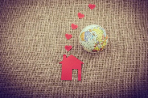 Heart shape coming out of chimney of paper house