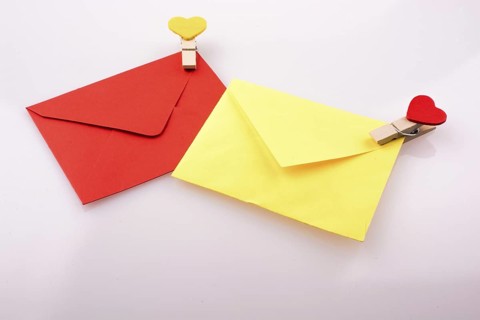 Heart shaped icons on clothespins attached to colorful envelops