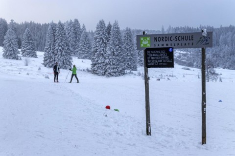 Sign Nordic school collection point in snowy landscape