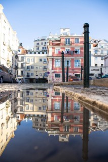 Old houses in narrow alleys and historic streets. Old house fronts in the morning and in the sunshine with reflection