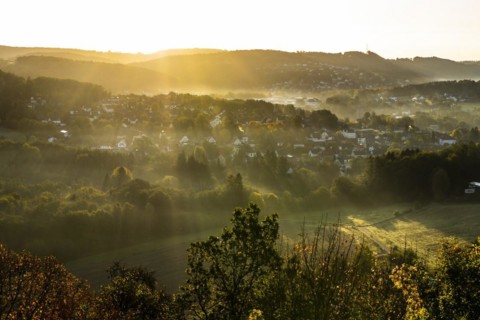 View from the ruins of Windeck Castle to the village of Schladern at sunrise and morning fog