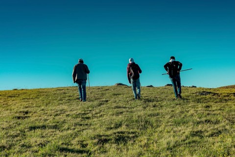 Hikers with backpacks and trekking poles walking in Turkish highland