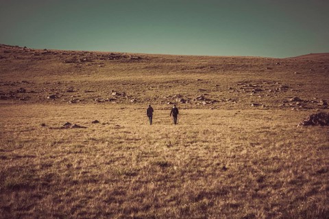 Hikers with backpacks and trekking poles walking in Turkish highland