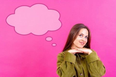 Thinking woman with many ideas with empty bubble on pink background