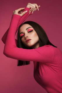 Beautiful brunette woman in pink clothes