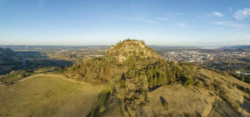 Panorama of the volcanic cone Hohentwiel with the castle ruins illuminated by the evening sun