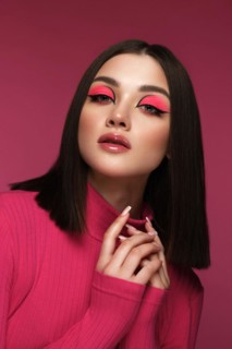 Beautiful brunette woman in pink clothes