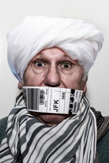Refugee for repatriation with a flying bandaroleer around his mouth
