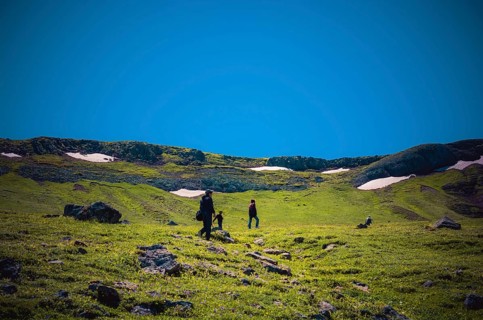Hikers with backpacks and trekking poles walking in Turkish highland