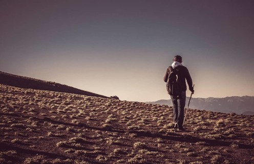 Hikers with backpacks and trekking poles walking in Turkish highland
