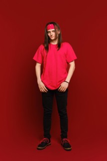 Full body indoor portrait of positive good-looking hipster guy wearing red band on head