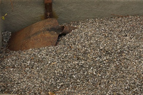 Rusty shovel and gravel