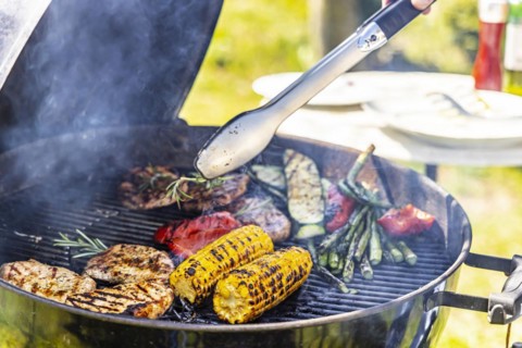 Charcoal grill in the garden with steaks and vegetarian barbecue