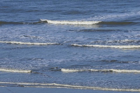 Leaking waves on a sandy beach