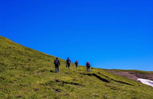 Hikers with backpacks and trekking poles walking in Turkish highland