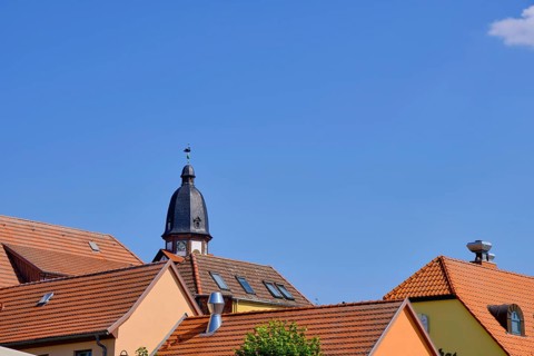 Roof structures and steeple of St. Mary's Church in the historic town centre of Waren an der Mueritz