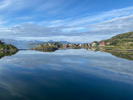 Crystal clear water and wooden houses reflected in the water