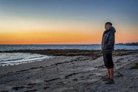 Old man standing on the coast of the Bay of Biscay
