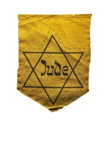 German Jewish badge showing yellow star saying Jude against white background