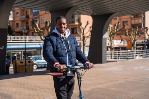 Black ethnic male skateboarding on an electric skate