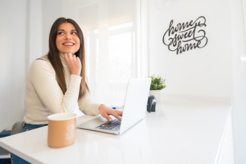 Business woman working on laptop sitting at home