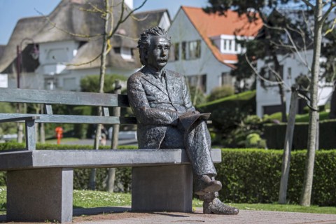 Albert Einstein statue sitting on a park bench at the seaside resort De Haan
