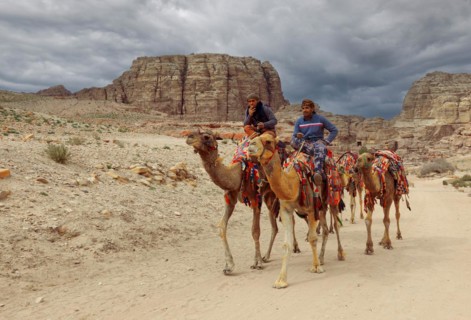 Bedouins with camels on horseback