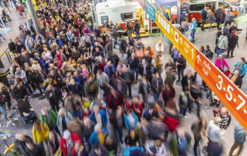 Entrance to the travel trade fair with many visitors