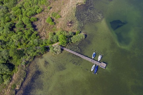Aerial view over sailing boats moored at wooden jetty in lake Ratzeburger