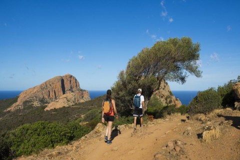 Red granite rocks and hikers