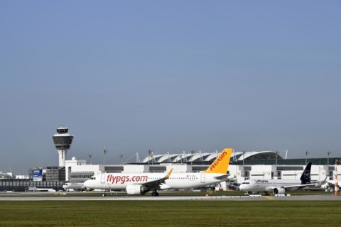 Pegasus Boeing B737 waiting for take-off clearance on runway south with tower