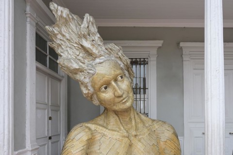 Imaginary deity â€œTalanaâ€ statue made of recycled cardboard in front the municipal library