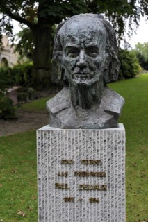 Bust of the surrealist painter Paul Delvaux in city park at Veurne
