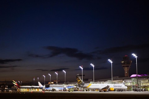 Terminal 1 at night with tower and Condor and TUI fly