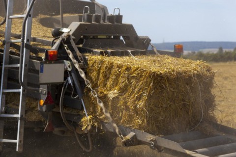 Tractor with a straw baler